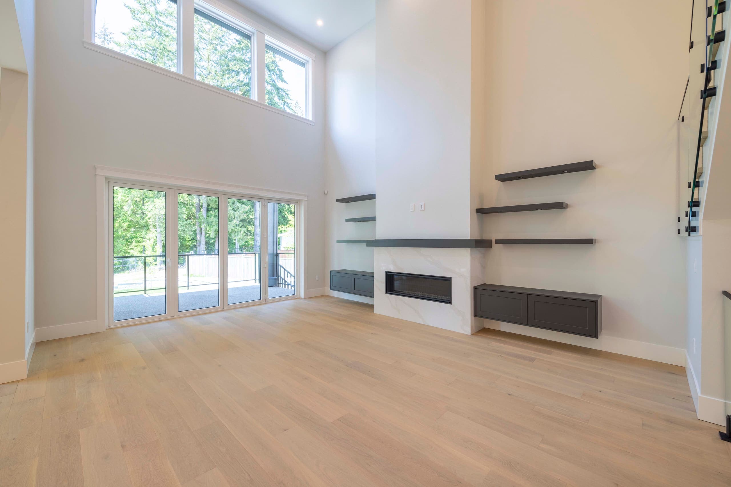 The finished double-height living room at The Ridge House, open to the deck and the trees